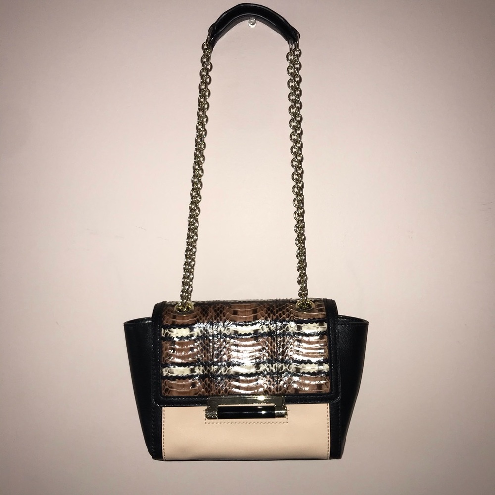 Cream, black, and animal print purse